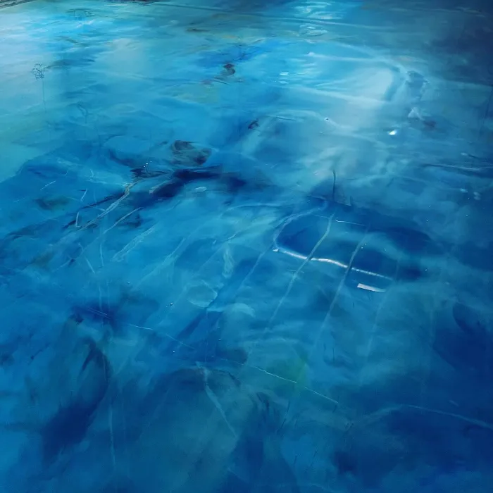 Metallic epoxy floor finish with a custom marbled design
